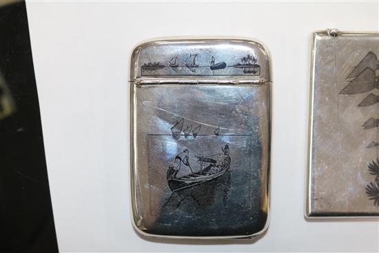 Two continental white metal and niello card cases and a similar cigarette case.